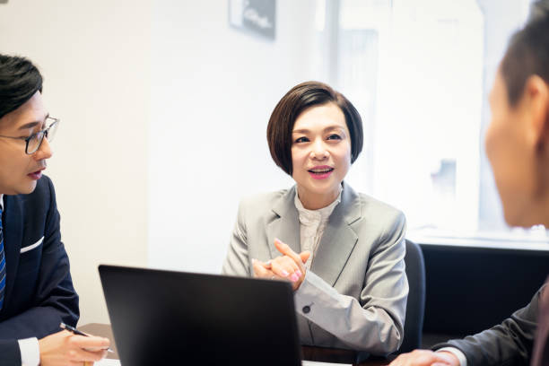 istock Asian manager talking to her business team 1181534815