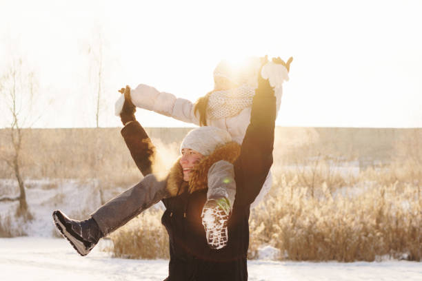 istock Teens brother and sister having fun snow in winter 1181536664