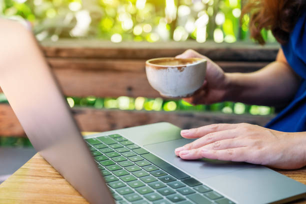 istock a woman using and touching on laptop touchpad while drinking coffee 1181536705