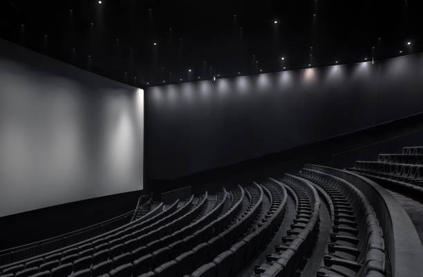 istock Black cinema white wide screen and auditorium seats 1181539359