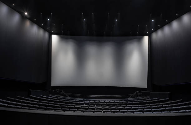 istock Black cinema white wide screen and auditorium seats 1181539361