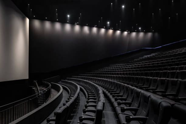 istock Black cinema white wide screen and auditorium seats 1181539362