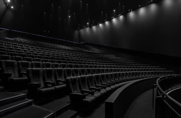 istock Black cinema white wide screen and auditorium seats 1181539371