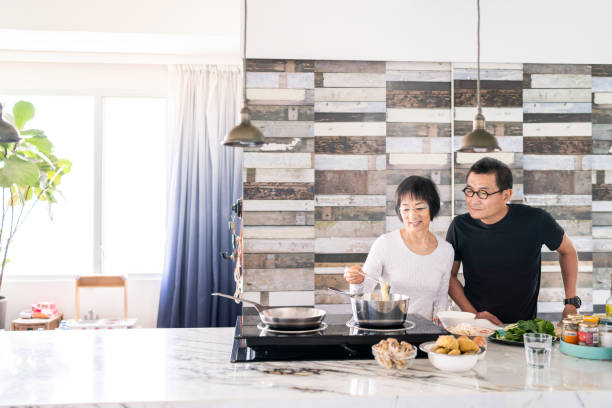 istock Chinese couple cooking in the kitchen 1181540127