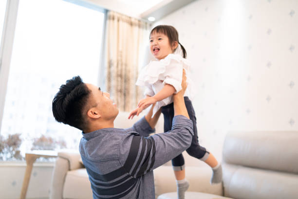 istock Happy Asian father lifting up his daughter 1181540290