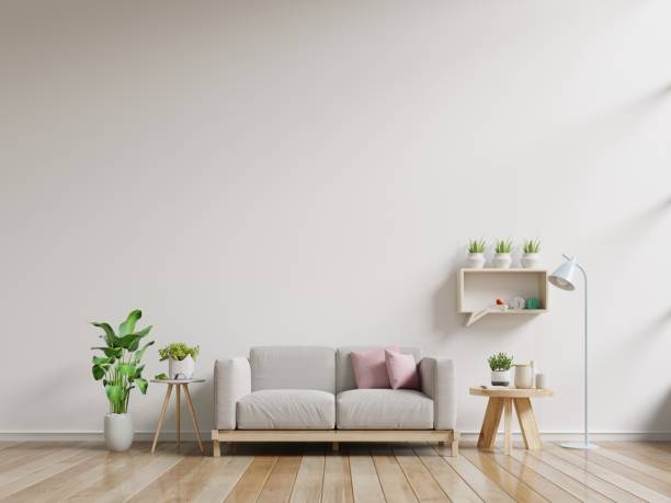 istock Interior wall mock up with sofa and wall shelves on empty white background. 1181546493