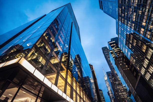 Futuristic skyscrapers at dusk Night view of modern skyscrapers in Midtown Manhattan. property styling stock pictures, royalty-free photos & images