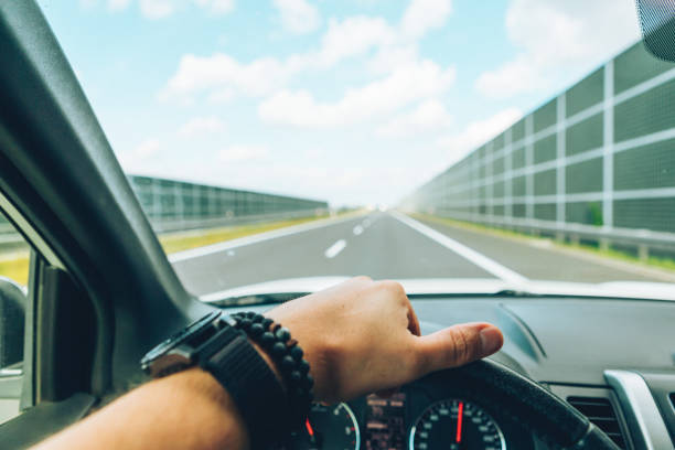 istock car travel concept man hand on steering wheel speedway copy space 1181556560