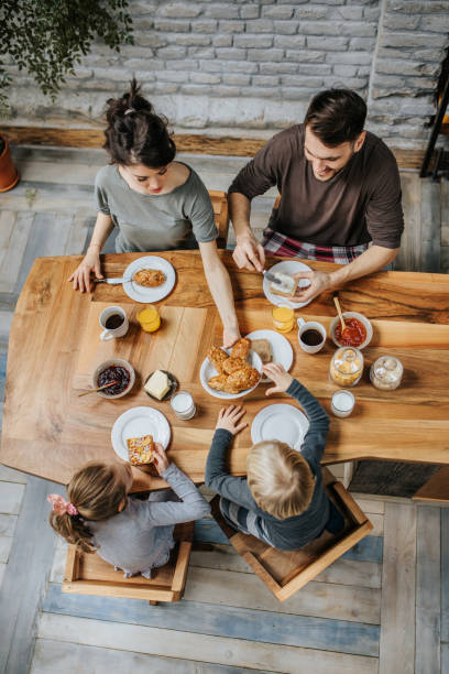Above view of a family having breakfast at dining table.