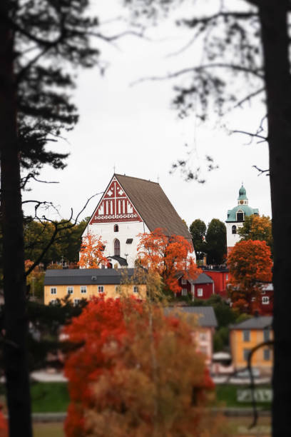 view of old porvoo, finland. beautiful city autumn landscape with porvoo cathedral and colorful wooden buildings. - medieval autumn cathedral vertical imagens e fotografias de stock