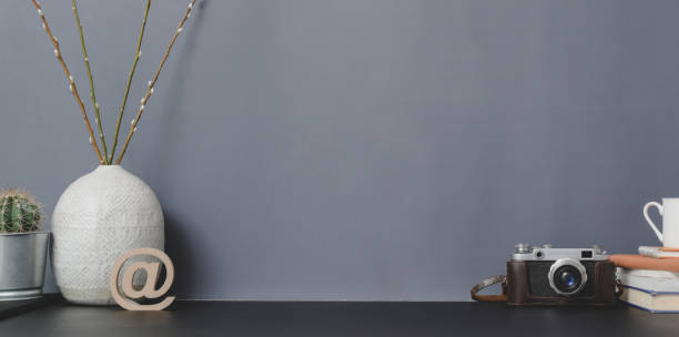 istock Contemporary workspace with camera and copy space with office supplies and ceramic vase 1181559993