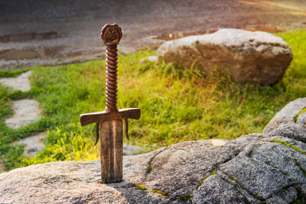 istock Excalibur, King Arthur's sword in stone. Edged weapons from the legend Pro king Arthur. 1181566189