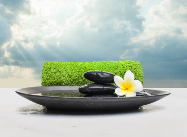 istock Spa objects and green towel on black plate. Spa healthy concept 1181566211