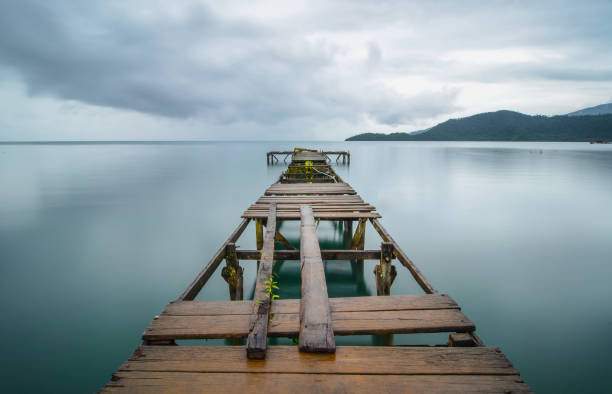 Broken Harbor Jetty in Slow shutter speed. The picture taken at the lake side of Towuti lake in South Sulawesi, Indonesia. makassar stock pictures, royalty-free photos & images