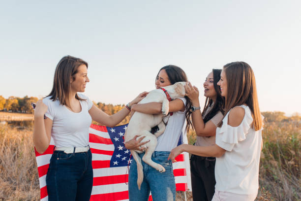 istock 4 girlfriends walking with a little Labrador puppy 1181568790