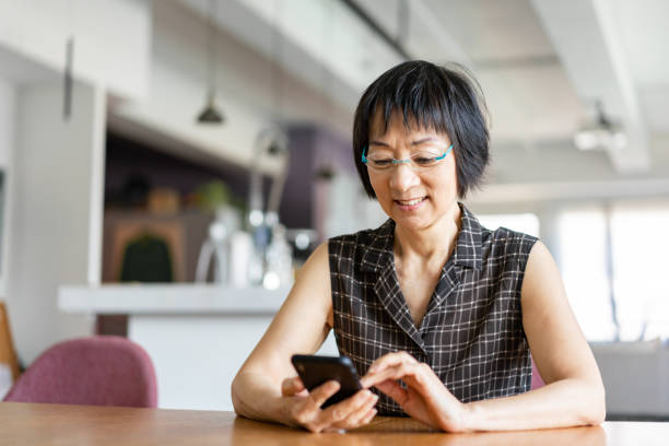 istock Senior Asian woman using a smartphone 1181568989