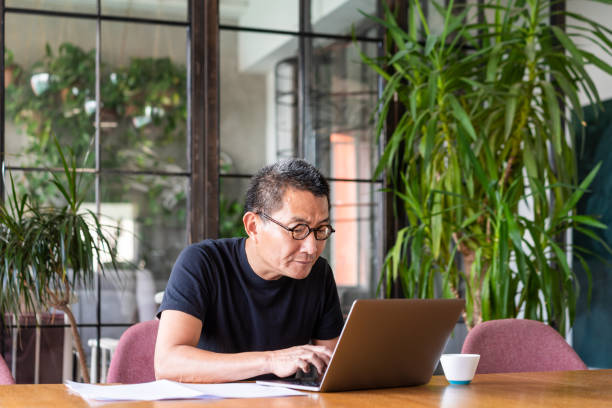 istock Chinese architect working on his laptop 1181569301