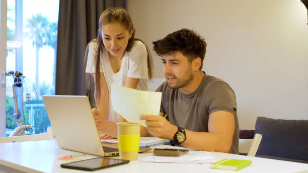 istock Young couple working at home 1181569415
