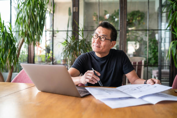 istock Senior Chinese architect working in his studio 1181570221