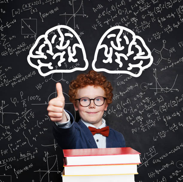 istock Little student boy 9 year old with books on chalkboard background 1181574346