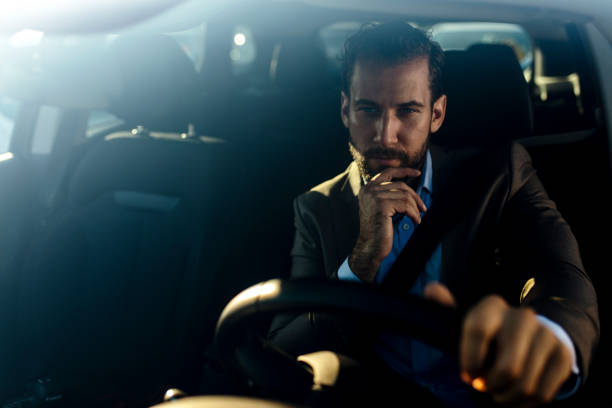 istock Attractive young man driving car 1181578304