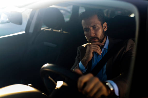 istock Traffic jam - stressed businessman driving car 1181579738
