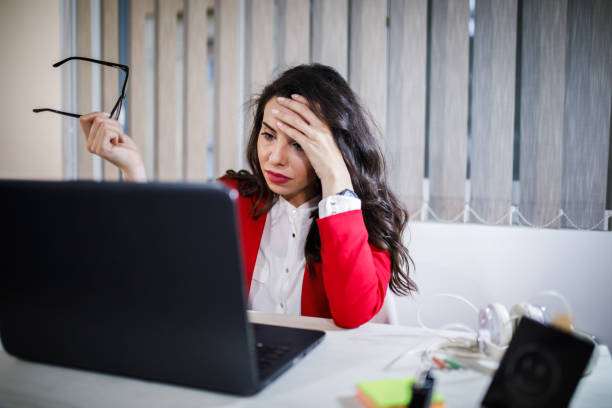 istock Tired young business woman with laptop computer 1181581330