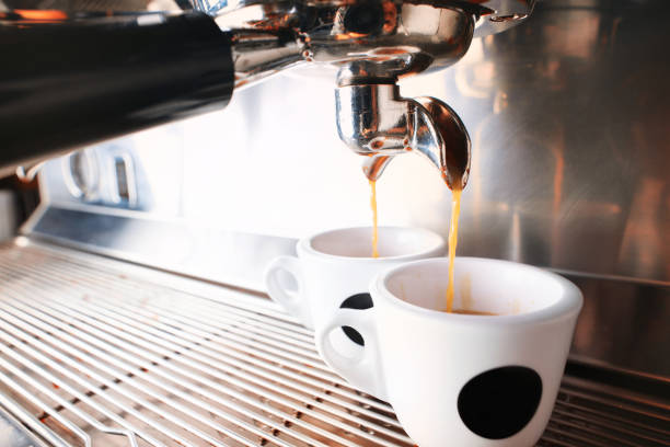 istock Stylish black espresso making machine brewing two cups of coffee, shooted in cafe. 1181581584