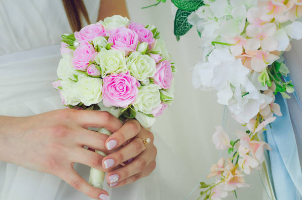 istock The bride is holding a wedding bouquet. Hands close-up. 1181581679