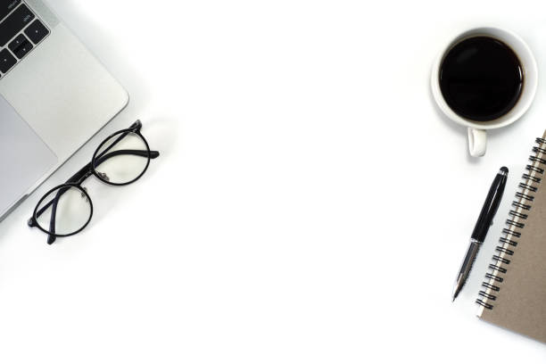 istock Flat lay, White office desk table with laptop, notebook, pen, black coffee cup and eyeglasses. Top view with copy space. 1181583766