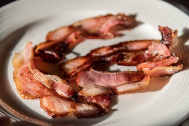 istock Isolated close up plate of delicious fried bacon 1181583884