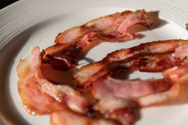 istock Isolated close up plate of delicious fried bacon 1181584672