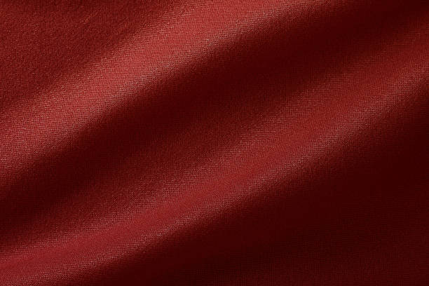 Dark red fabric cloth texture for background and design art work, beautiful crumpled pattern of silk or linen.