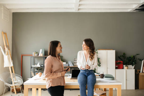 istock Two Businesswomen Chatting at Work 1181585213