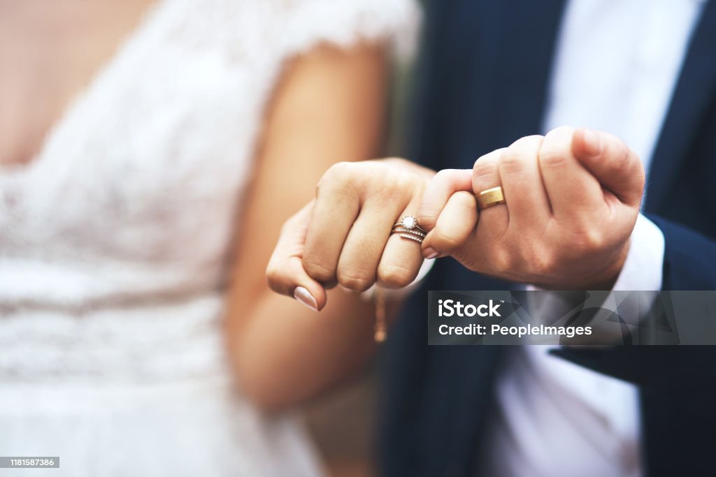 I pinky promise I'll be by your side forever Cropped shot of an unrecognizable newlywed couple doing a pinky swear gesture on their wedding day Wedding Stock Photo