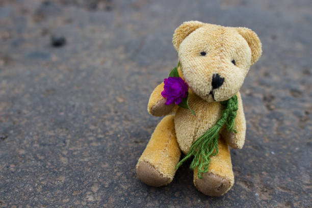 istock Bear Doll Sitting on Asphalt 1181588640