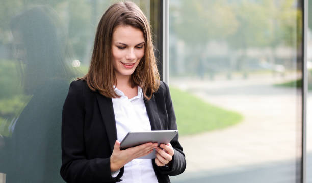 istock Smiling businesswoman using a digital tablet outdoor 1181589068
