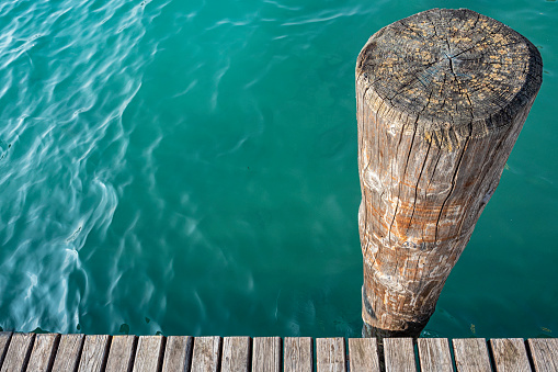 Wood mooring pole on Lake Garda