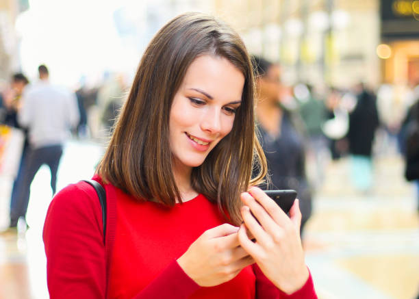 istock Young woman using a smartphone outdoor 1181589980