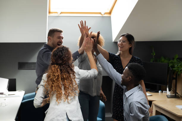istock Workers giving high five gesture of common success sharing 1181590426