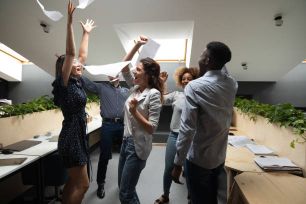 istock Successful multiethnic workers scream with joy celebrating accomplishment of project 1181590438