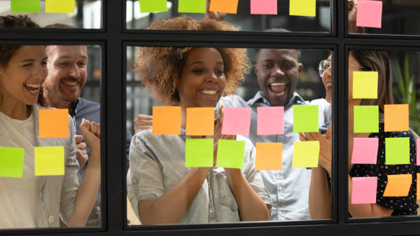 istock Diverse team celebrating accomplishment of profitable commercial project 1181590470