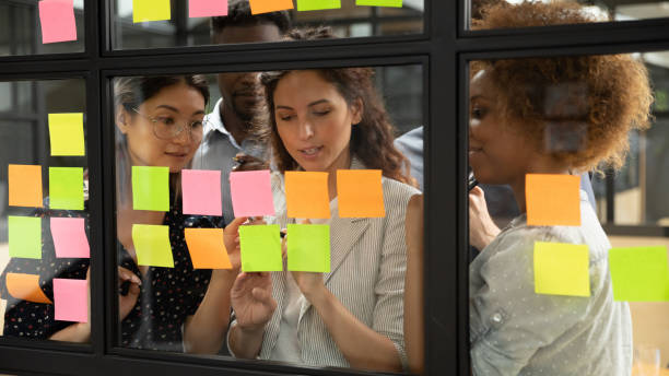istock Group of multiracial businesspeople creating business plan using sticky notes 1181590472