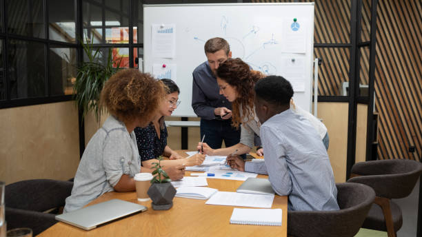 istock Multiethnic workers gathered together for reviewing financial statistical data 1181590479