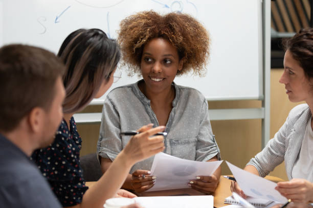 istock Creative group of businesspeople discussing new project using documents 1181590490