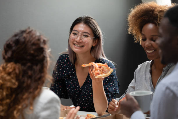istock Asian office worker eat pizza together with workmates 1181590495