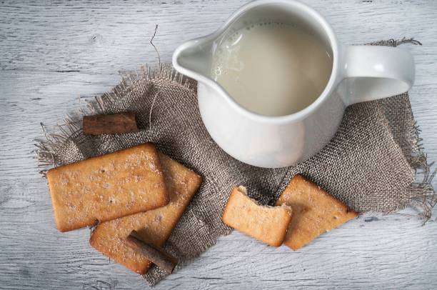 istock Milk jug with cinnamon cookies on wood 1181591341