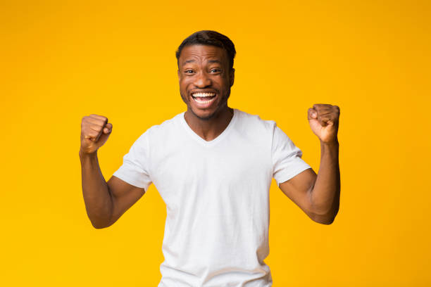 istock Black Guy Shouting Shaking Fists Standing On Yellow Background 1181591430