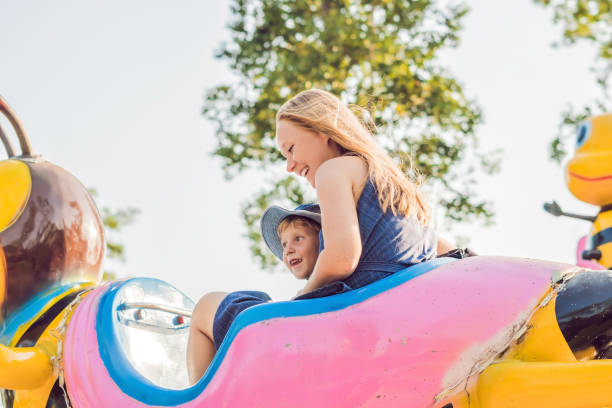 istock Mom and son having fun at an amusement park 1181591480