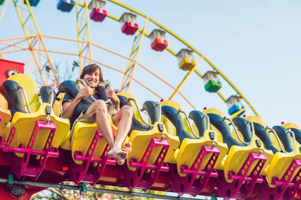 istock Beautiful, young man having fun at an amusement park 1181591510